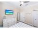 Bedroom has large dresser, ceiling fan, and TV with outdoor scenery at 2002 Bal Harbor Blvd # 1022, Punta Gorda, FL 33950