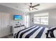 Bright bedroom features nautical decor, a ceiling fan, and balcony access at 2002 Bal Harbor Blvd # 1022, Punta Gorda, FL 33950