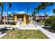 Community clubhouse featuring manicured landscaping, handicap access ramp, and welcoming entry at 2002 Bal Harbor Blvd # 1022, Punta Gorda, FL 33950