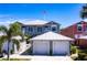 Charming two-story home featuring a white metal roof, double garage, and well-maintained landscaping at 2002 Bal Harbor Blvd # 1022, Punta Gorda, FL 33950