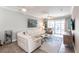 Bright living room with a comfortable sectional sofa, large windows, and access to an outdoor balcony at 2002 Bal Harbor Blvd # 1022, Punta Gorda, FL 33950