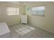 Bedroom with tiled floors, neutral walls, and two windows providing natural light at 22191 New Rochelle Ave, Port Charlotte, FL 33952