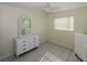 Bedroom featuring tiled floors, a ceiling fan, and two white dressers for ample storage space at 22191 New Rochelle Ave, Port Charlotte, FL 33952