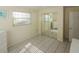 Bedroom with tiled floors, closet with mirrored doors, and a window providing natural light at 22191 New Rochelle Ave, Port Charlotte, FL 33952