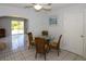 Cozy dining area with a glass table, seating for four, and tile flooring at 22191 New Rochelle Ave, Port Charlotte, FL 33952
