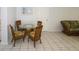 Cozy dining area with a glass-top table and comfortable seating, adjacent to the living area at 22191 New Rochelle Ave, Port Charlotte, FL 33952