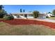 Charming home with well-maintained lawn, driveway, and mature landscaping for curb appeal at 22191 New Rochelle Ave, Port Charlotte, FL 33952