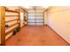 Spacious garage featuring ample storage shelves, a light-colored floor, and a bright ceiling at 22191 New Rochelle Ave, Port Charlotte, FL 33952