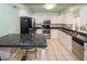 Bright kitchen with white cabinets, stainless steel appliances, and a breakfast bar at 22191 New Rochelle Ave, Port Charlotte, FL 33952