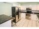 Well-equipped kitchen featuring stainless steel appliances, white cabinets, and a modern design at 22191 New Rochelle Ave, Port Charlotte, FL 33952