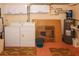 Laundry room featuring a washer and dryer, overhead storage, and hot water heater at 22191 New Rochelle Ave, Port Charlotte, FL 33952
