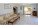 Comfortable living room featuring tile floors, a ceiling fan, and access to an outdoor patio at 22191 New Rochelle Ave, Port Charlotte, FL 33952