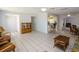 Open-concept living area with tile flooring and view into adjacent kitchen at 22191 New Rochelle Ave, Port Charlotte, FL 33952