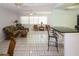 Bright, open living space with tile floors and view from bar counter seating at 22191 New Rochelle Ave, Port Charlotte, FL 33952