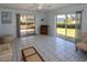 Bright living room with tile flooring, sliding glass doors, and cozy seating at 22191 New Rochelle Ave, Port Charlotte, FL 33952