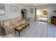 Comfortable living room featuring tile floors, a ceiling fan, and access to an outdoor patio at 22191 New Rochelle Ave, Port Charlotte, FL 33952