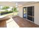 Covered outdoor patio with tile flooring and screens overlooking the backyard at 22191 New Rochelle Ave, Port Charlotte, FL 33952