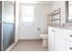 Bathroom featuring a shower with glass doors, white vanity, and a window for natural light at 23179 Maclellan Ave, Port Charlotte, FL 33980