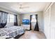 Bedroom showcasing a plaid comforter, ceiling fan, closet, and television on a dresser at 23179 Maclellan Ave, Port Charlotte, FL 33980