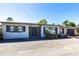 Exterior shot of a single-story home with a driveway, minimal landscaping, and a modern double-door entrance at 23179 Maclellan Ave, Port Charlotte, FL 33980