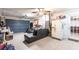 Garage space including a couch, refrigerator, and overhead storage at 23179 Maclellan Ave, Port Charlotte, FL 33980