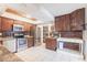 Charming kitchen features rustic wood cabinets, granite countertops, and stainless steel appliances at 23179 Maclellan Ave, Port Charlotte, FL 33980