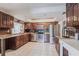 Kitchen showcases wood cabinets, stainless steel appliances, light tile floor, and a breakfast bar at 23179 Maclellan Ave, Port Charlotte, FL 33980