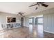 Spacious living room showcasing tile flooring, neutral walls, and a wide opening to another room at 23179 Maclellan Ave, Port Charlotte, FL 33980