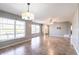 Open living room area featuring tile floors, neutral paint, ceiling fan, and multiple windows for lots of light at 23179 Maclellan Ave, Port Charlotte, FL 33980
