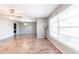 Open living room featuring tile floors, neutral paint, a ceiling fan, and a floor lamp at 23179 Maclellan Ave, Port Charlotte, FL 33980