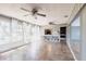 A well-lit living room featuring tile flooring, neutral walls, and openings to other rooms at 23179 Maclellan Ave, Port Charlotte, FL 33980