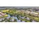 A beautiful aerial view of the community with a winding waterway and lush trees in a desirable location at 238 Southampton Dr # 319, Venice, FL 34293
