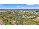 Scenic aerial view showcasing community's waterways and lush greenery across the neighborhood at 238 Southampton Dr # 319, Venice, FL 34293