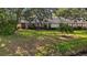 Lush backyard with mature trees, a well-maintained lawn, and serene views of the surrounding greenery at 238 Southampton Dr # 319, Venice, FL 34293