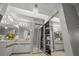 Bright bathroom features dual sinks, vanities, mirrored closets and a chandelier at 238 Southampton Dr # 319, Venice, FL 34293