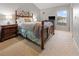Well-lit bedroom features a wooden bed frame and matching nightstands at 238 Southampton Dr # 319, Venice, FL 34293