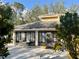 Exterior view of the community building featuring a patio area and well-maintained landscaping at 238 Southampton Dr # 319, Venice, FL 34293