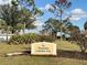 The Plantation Community Park entrance sign surrounded by lush landscaping under a blue sky at 238 Southampton Dr # 319, Venice, FL 34293