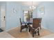 Cozy dining room featuring a glass table with wicker chairs and bright natural light at 238 Southampton Dr # 319, Venice, FL 34293