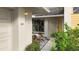 Inviting entrance showcasing a well-lit walkway, beautiful landscaping, and a glimpse of the home's interior at 238 Southampton Dr # 319, Venice, FL 34293