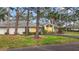 Charming single-story home featuring a well-maintained lawn, mature trees, and a welcoming front entrance at 238 Southampton Dr # 319, Venice, FL 34293