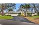 Charming home with a tile roof, an attached garage, and a curved driveway lined with well-maintained landscaping at 238 Southampton Dr # 319, Venice, FL 34293