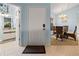 Open foyer area leading to a dining space with seating for four, with a bathroom and entry door visible at 238 Southampton Dr # 319, Venice, FL 34293