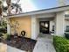 Inviting front entrance with double doors, attractive landscaping, and neutral exterior colors at 238 Southampton Dr # 319, Venice, FL 34293