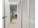 Hallway view featuring built-in closet and open access to the neutrally decorated space beyond at 238 Southampton Dr # 319, Venice, FL 34293
