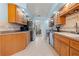 Functional kitchen with light wood cabinets and stainless steel appliances at 238 Southampton Dr # 319, Venice, FL 34293