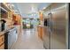 Modern kitchen featuring stainless steel appliances, ample counter space, and an open layout with a view of the lanai at 238 Southampton Dr # 319, Venice, FL 34293