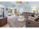 Spacious living room with vaulted ceilings, comfortable seating, and serene water views from the dining area at 238 Southampton Dr # 319, Venice, FL 34293