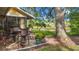 Patio view of home featuring pond, green lawn and outdoor dining set under a shady tree at 238 Southampton Dr # 319, Venice, FL 34293