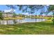 Scenic waterfront view featuring lush landscaping and a tranquil pond surrounded by well-maintained properties at 238 Southampton Dr # 319, Venice, FL 34293